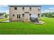 Expansive backyard with a lush green lawn, covered barbecue, and patio area at 1610 Kenilworth Se Ln, Conyers, GA 30013