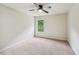 Bedroom with a ceiling fan and a window overlooking a lush green view at 1610 Kenilworth Se Ln, Conyers, GA 30013