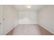 Spacious bedroom with plush carpeting, a door to the left, and ample natural light at 1610 Kenilworth Se Ln, Conyers, GA 30013