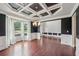 Elegant dining room with coffered ceiling, bay window, and dark hardwood floors at 1610 Kenilworth Se Ln, Conyers, GA 30013