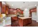 Modern kitchen featuring stainless steel appliances, dark wood cabinets and a granite topped center island at 1610 Kenilworth Se Ln, Conyers, GA 30013