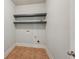 Small laundry room with tile floors and shelving at 1610 Kenilworth Se Ln, Conyers, GA 30013