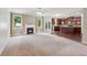 Spacious living room with fireplace, large windows, seamlessly connecting to the open kitchen area at 1610 Kenilworth Se Ln, Conyers, GA 30013