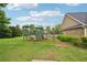 Community playground featuring green play structures on a grassy lawn at 1610 Kenilworth Se Ln, Conyers, GA 30013