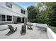 Back patio with gray stone, outdoor seating, and a view of the lush greenery of the backyard at 167 Garden Ln, Decatur, GA 30030
