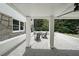 Covered back patio with gravel flooring, a stone wall, and comfortable outdoor seating at 167 Garden Ln, Decatur, GA 30030