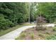 Relaxing backyard with a stone walkway, lush greenery, and a pair of blue chairs at 167 Garden Ln, Decatur, GA 30030