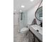 Modern bathroom with a glass-enclosed shower, a sleek vanity, and a round mirror at 167 Garden Ln, Decatur, GA 30030
