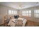 Cozy bedroom with ceiling fan, white shutters on the windows, and a comfortable bed with stylish bedding at 167 Garden Ln, Decatur, GA 30030
