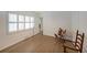 Bright, open bedroom with two modern chairs, hardwood flooring, and a pair of shuttered windows at 167 Garden Ln, Decatur, GA 30030