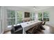 Bright dining area with picture frame windows and a table set for eight with views of the back yard at 167 Garden Ln, Decatur, GA 30030