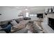 Cozy living room featuring a plush gray sectional, zebra rug, and a brick fireplace at 167 Garden Ln, Decatur, GA 30030