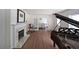 Bright living room with fireplace, hardwood floors, and a piano at 167 Garden Ln, Decatur, GA 30030
