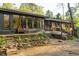 Backyard featuring landscaping, brick accents and a brick home with large picture windows at 1850 Winchester Trl, Brookhaven, GA 30341