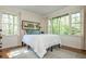 Bright bedroom features large windows with views of nature at 1850 Winchester Trl, Brookhaven, GA 30341