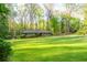 Lush front lawn surrounds this cozy home with mature trees, shrubs, and meticulously maintained landscaping at 1850 Winchester Trl, Brookhaven, GA 30341