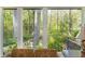 Serene view of the lush, mature trees surrounding the home with stone picnic table at 1850 Winchester Trl, Brookhaven, GA 30341