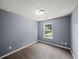 Cozy bedroom with neutral carpeting, textured ceiling, and a window offering natural light at 2776 Snapfinger Mnr # 2776, Decatur, GA 30035