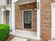 Inviting front entrance with a black door, brick facade, white accents, and manicured greenery at 2776 Snapfinger Mnr # 2776, Decatur, GA 30035