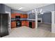 Well-lit kitchen featuring wooden cabinetry and view into living room with fireplace at 2776 Snapfinger Mnr # 2776, Decatur, GA 30035