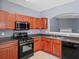 Bright kitchen features stainless steel appliances, wood cabinets, and an open archway at 2776 Snapfinger Mnr # 2776, Decatur, GA 30035
