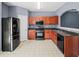 Charming kitchen with stainless steel appliances, wooden cabinets, and light-colored tile flooring at 2776 Snapfinger Mnr # 2776, Decatur, GA 30035