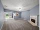 Spacious living room with cozy fireplace, neutral carpet, and open layout to the dining area at 2776 Snapfinger Mnr # 2776, Decatur, GA 30035