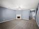 Bright living room with neutral walls, carpet, fireplace, and a view of the doorway at 2776 Snapfinger Mnr # 2776, Decatur, GA 30035