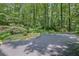 Lush backyard with a stone fire pit and driveway, offering a private outdoor space at 1279 Colony Pl, Marietta, GA 30068