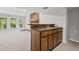 Finished basement area with stone fireplace and a wet bar featuring wooden cabinets at 1279 Colony Pl, Marietta, GA 30068