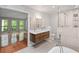 Elegant bathroom with a double vanity, a glass-enclosed shower, and an adjacent room with views at 1279 Colony Pl, Marietta, GA 30068