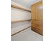 An organized walk-in closet with wood shelving and cabinetry, offering ample storage space at 1279 Colony Pl, Marietta, GA 30068