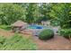 Community pool with lounge chairs, umbrellas, and a covered pavilion surrounded by lush landscaping at 1279 Colony Pl, Marietta, GA 30068