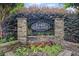 Elegant stone entrance sign for Lake Colony, surrounded by vibrant flowering shrubs and manicured landscaping at 1279 Colony Pl, Marietta, GA 30068