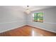 A well-lit dining room featuring hardwood floors, neutral walls, and a window with outdoor views at 1279 Colony Pl, Marietta, GA 30068