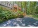 Charming gray home featuring multiple wood decks surrounded by lush greenery and natural stone landscaping at 1279 Colony Pl, Marietta, GA 30068