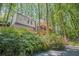 Rear exterior of home with multi-level decks nestled among mature trees at 1279 Colony Pl, Marietta, GA 30068