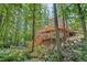 Gray home features multi-tiered wooden decks, surrounded by lush trees offering a private and secluded setting at 1279 Colony Pl, Marietta, GA 30068