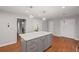 A beautifully updated kitchen featuring an island with gray cabinets, white countertops, and hardwood flooring at 1279 Colony Pl, Marietta, GA 30068