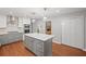 A modern kitchen with an island, stainless steel appliances, and hardwood floors, adjacent to a stone fireplace at 1279 Colony Pl, Marietta, GA 30068