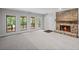 Open living room with stone fireplace, large windows, and natural light at 1279 Colony Pl, Marietta, GA 30068