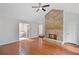 Spacious living room with a stone fireplace, hardwood floors, and an open doorway to a bathroom with a soaking tub at 1279 Colony Pl, Marietta, GA 30068