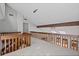 Bright loft area with wooden beam and railing, offering a cozy and open space within the home at 1279 Colony Pl, Marietta, GA 30068