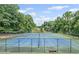 Well-maintained tennis courts surrounded by trees and landscaping, providing a recreational amenity for residents at 1279 Colony Pl, Marietta, GA 30068