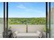 Enjoy tranquil green views from this outdoor balcony with a cozy loveseat at 2575 Peachtree Ne Rd # 15F, Atlanta, GA 30305