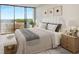 Bright bedroom boasts balcony access with green views, a comfortable bed, and stylish decor at 2575 Peachtree Ne Rd # 15F, Atlanta, GA 30305