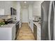 Modern, galley kitchen featuring stainless steel appliances, and quartz countertops at 2575 Peachtree Ne Rd # 15F, Atlanta, GA 30305