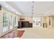 Open basement area with a wet bar, French doors to deck, and adjacent sitting room at 3741 Cape York Trce, Alpharetta, GA 30022