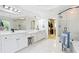 Bathroom featuring dual vanities, a soaking tub, and a glass-enclosed shower and walk in closet at 3741 Cape York Trce, Alpharetta, GA 30022