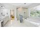 Luxurious bathroom featuring dual vanities, a soaking tub, and a glass-enclosed shower at 3741 Cape York Trce, Alpharetta, GA 30022